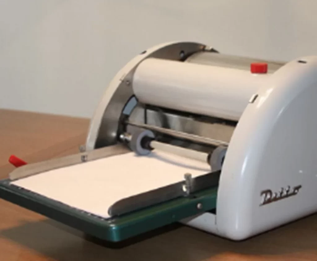 Vintage mimeo machine used for duplicating documents.